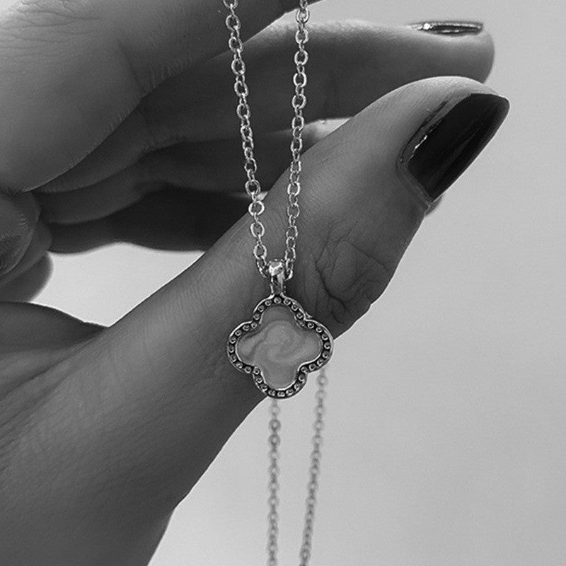 Stylish four-leaf clover necklace shown on a model