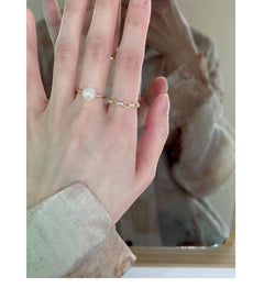 Butterfly ring with pearl accent on display