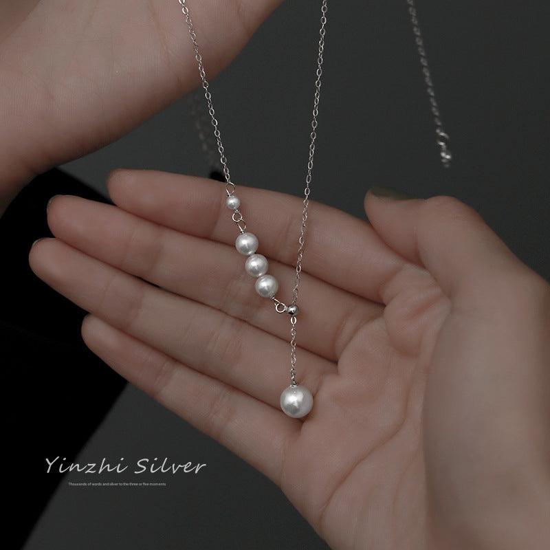 Elegant S925 silver tassel pearl necklace on display