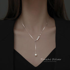 Tassel pearl necklace against a soft background