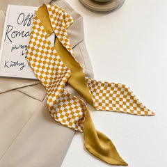 flat lay of yellow floral scarf on white background