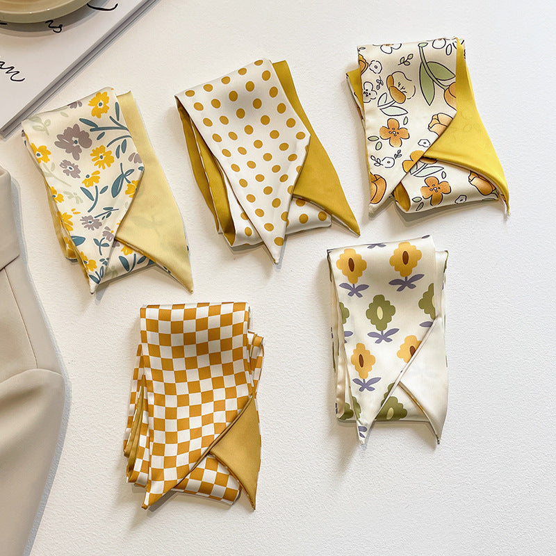 flat lay of yellow floral scarf on white background